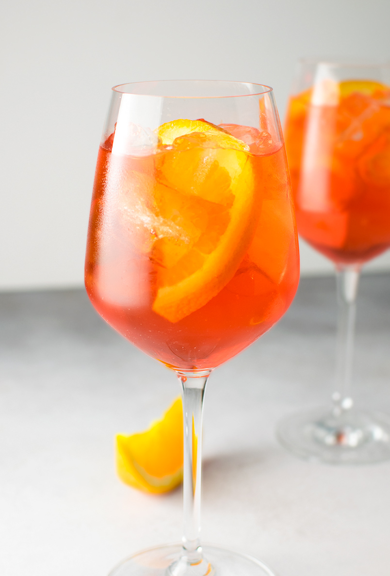 Photo and recipe by Kitchen Swagger.There is no denying that the classic cocktail, the Aperol Spritz, has been making a huge comeback this season. We've seen it popping up on wedding day bar menus and are loving the reemergence of this classic drink.